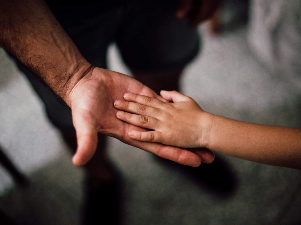 child hand in adult hand